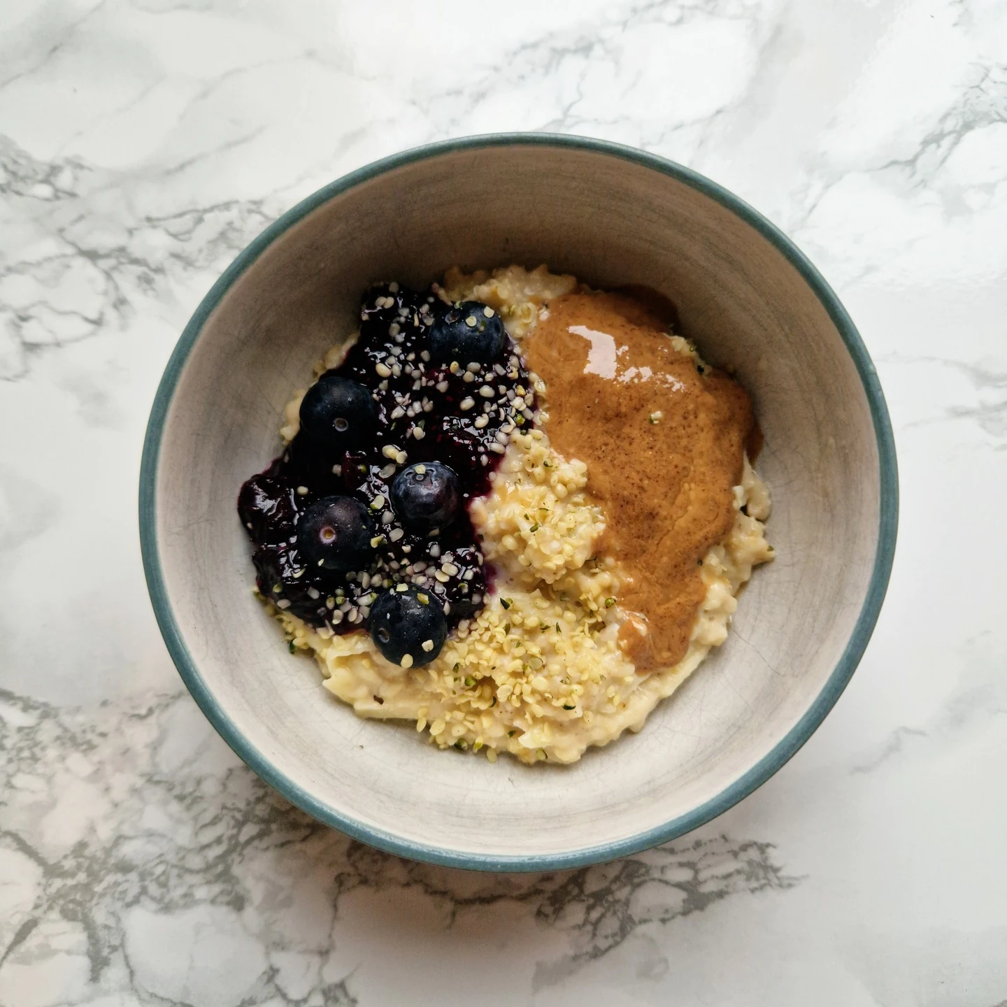Porridge topped with fresh blueberries and nut butter