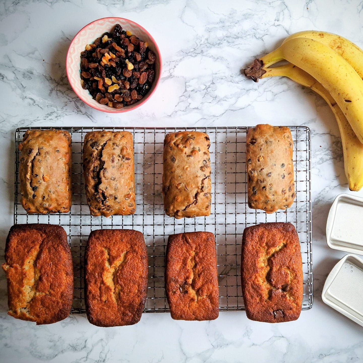 Mini banana loaves on wire rack with fruit