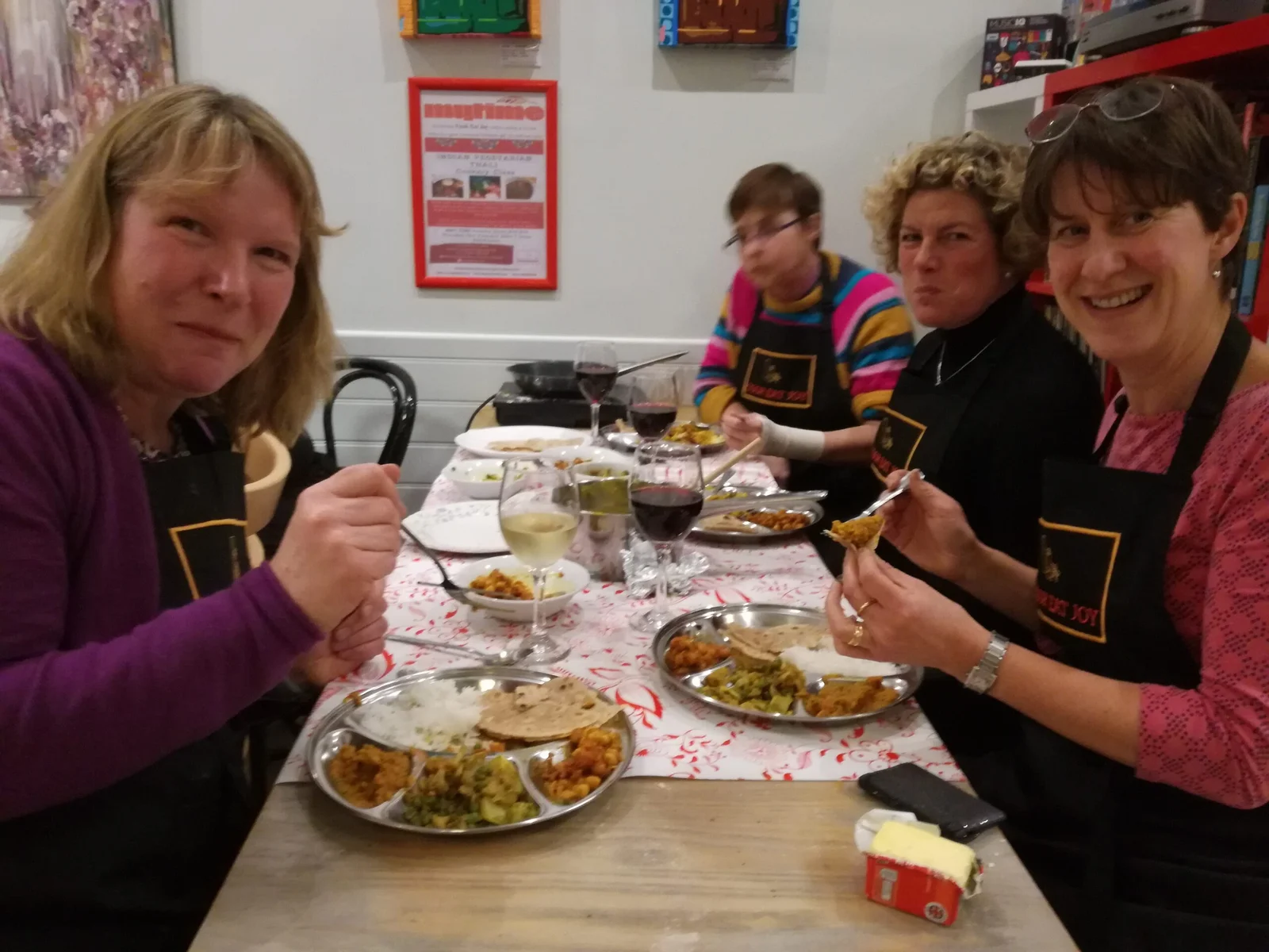 Dinner feast with happy students eating Indian meal