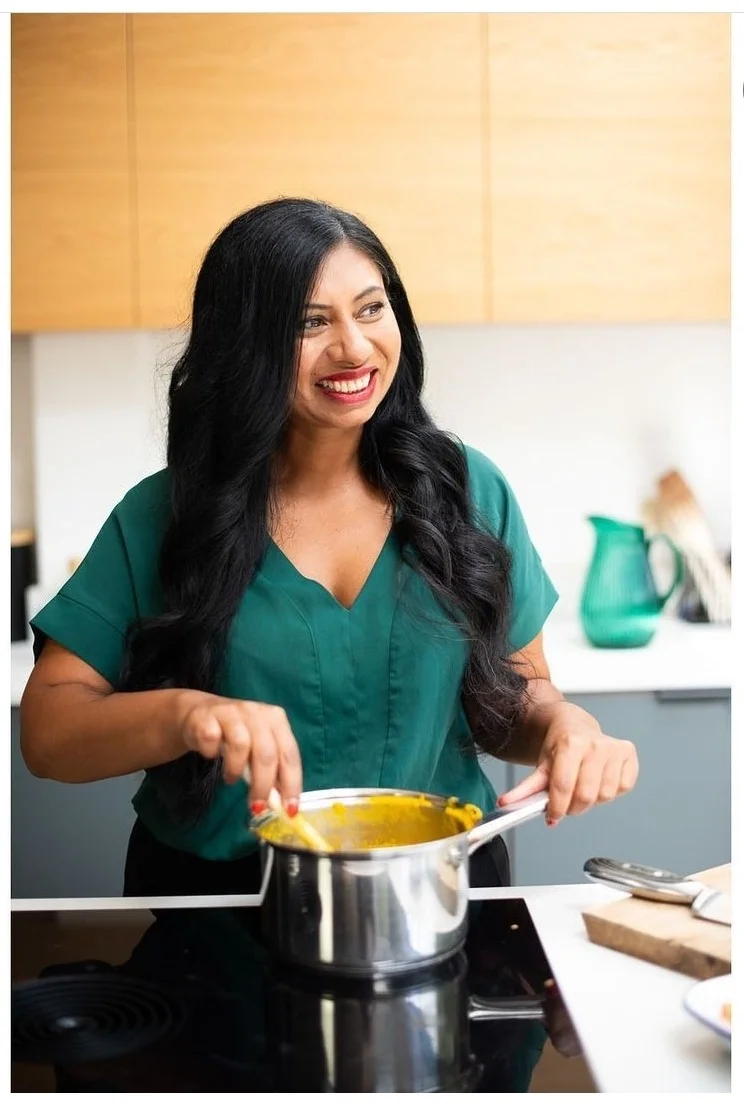 Ela laughing and stirring yellow curry