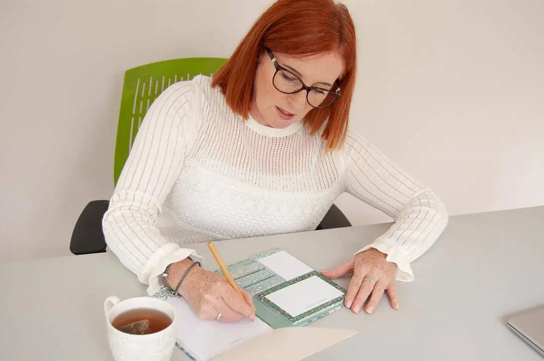 Deirdre reviewing clinical notes and questionnaires